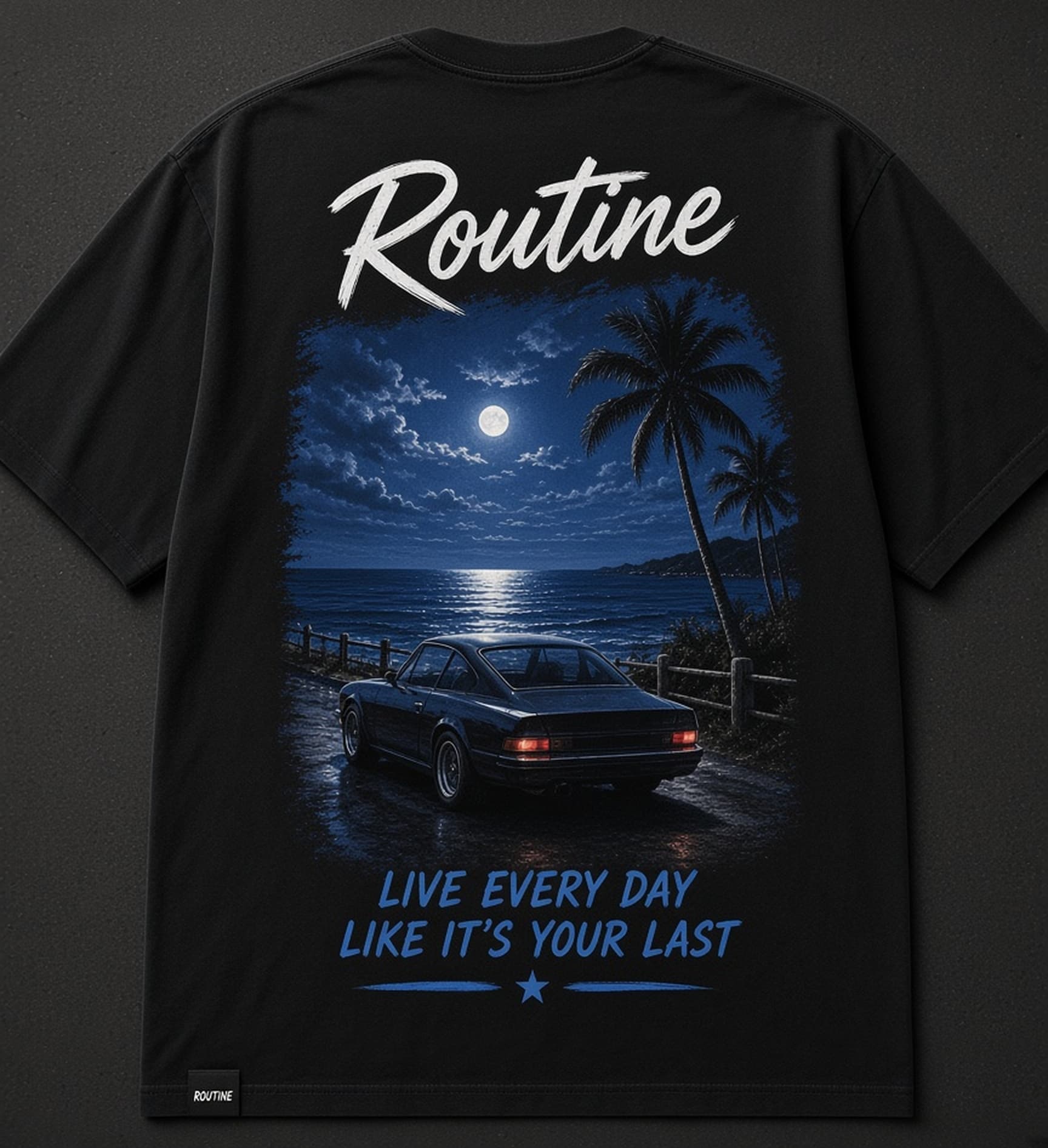 Back of a washed black Routine tee. Brush script ROUTINE above a moonlit ocean lookout print with a parked car, palms, and the tagline Live every day like it's your last.
